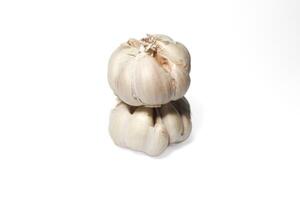 two garlic cloves stacked on top of each other. isolated background. white background. photo