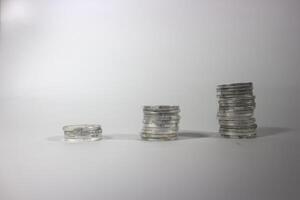 Coin on white background, stacked coins, isolated, sort by level, Indonesian Rupiah. investment and saving concept photo