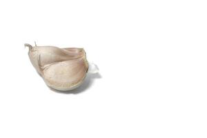 A piece of garlic isolated. Raw garlic with segments isolated on white background. photo