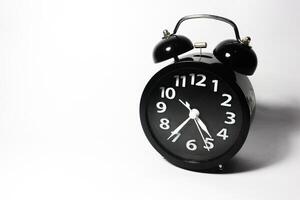 Classic black table clock isolated on a white background. copy space photo