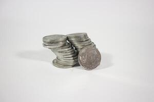 collection of Indonesian rupiah coins on a white background. Stack of Indonesian rupiah coins. Stack of Silver Coins. Financial concept. Copy space. isolated on white photo