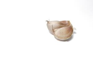 A piece of garlic isolated. Raw garlic with segments isolated on white background. photo