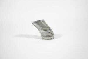 tilted stack of Indonesian rupiah coins. debt concept. isolated background photo