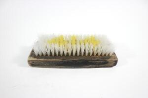 Old traditional manual clothes brusher made of wood on white background. Isolated white background. photo