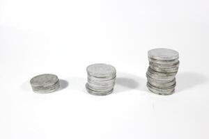 Coin on white background, stacked coins, isolated, sort by level, Indonesian Rupiah. investment and saving concept photo