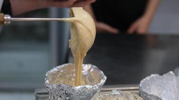Beating eggs with an electric mixer for sponge biscuit cake dough.. process of baking rich bread in homemade foil molds. Preparing the batter for the bent cake video