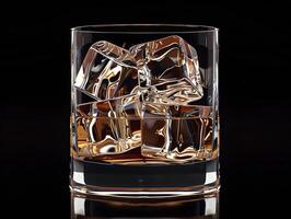 Whiskey with ice in a transparent glass photo