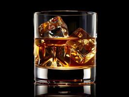 Whiskey with ice in a transparent glass photo