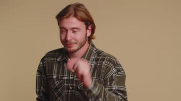 Man showing a little bit gesture with sceptic smile, showing minimum sign, measuring small size video