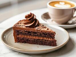 A piece of chocolate cake and coffee on the table photo