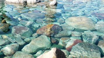 stones in the clear water. Pebbles under water. The view from the top photo