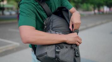 Close-up of a man with a backpack searching his bag and realizing he had lost something. video