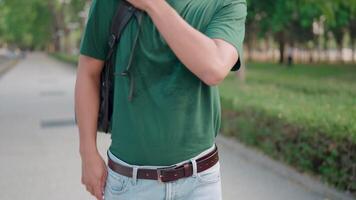 Close-up of a man carrying a backpack while walking on campus near the universit video