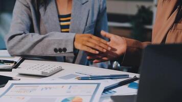 Office colleagues have a casual discussion. During a meeting in a conference room, a group of business teem sit in the conference room new startup project video