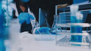 Scientists analyzing coronavirus study data and evaluating microscope. Health care researchers doing some research virus with dropper chemical testing and working in life science laboratory. video