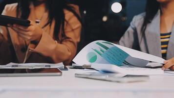 Office colleagues have a casual discussion. During a meeting in a conference room, a group of business teem sit in the conference room new startup project video