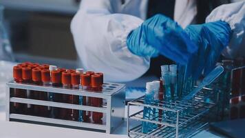 Scientists analyzing coronavirus study data and evaluating microscope. Health care researchers doing some research virus with dropper chemical testing and working in life science laboratory. video
