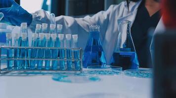 Scientists analyzing coronavirus study data and evaluating microscope. Health care researchers doing some research virus with dropper chemical testing and working in life science laboratory. video