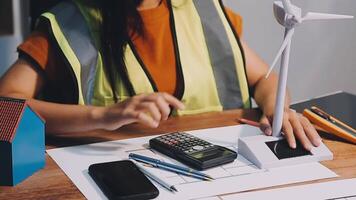 Selective focus, Asian female architect or engineer Currently considering materials for designing modern condominiums. Asian female architect or engineer Sit and analyze, design projects in the office video
