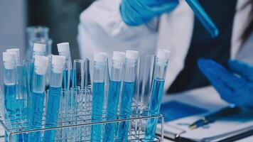 Scientists analyzing coronavirus study data and evaluating microscope. Health care researchers doing some research virus with dropper chemical testing and working in life science laboratory. video