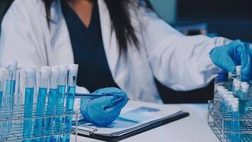 Scientists analyzing coronavirus study data and evaluating microscope. Health care researchers doing some research virus with dropper chemical testing and working in life science laboratory. video