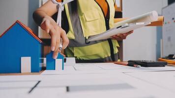 Selective focus, Asian female architect or engineer Currently considering materials for designing modern condominiums. Asian female architect or engineer Sit and analyze, design projects in the office video