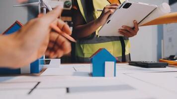 Selective focus, Asian female architect or engineer Currently considering materials for designing modern condominiums. Asian female architect or engineer Sit and analyze, design projects in the office video