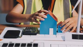 Selective focus, Asian female architect or engineer Currently considering materials for designing modern condominiums. Asian female architect or engineer Sit and analyze, design projects in the office video