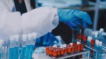 Scientists analyzing coronavirus study data and evaluating microscope. Health care researchers doing some research virus with dropper chemical testing and working in life science laboratory. video