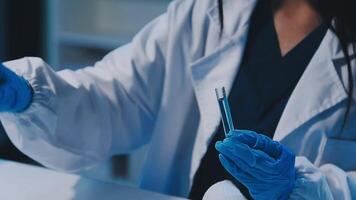 Scientists analyzing coronavirus study data and evaluating microscope. Health care researchers doing some research virus with dropper chemical testing and working in life science laboratory. video