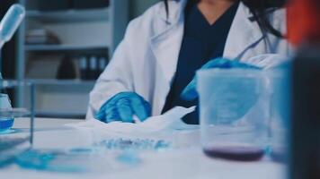 Scientists analyzing coronavirus study data and evaluating microscope. Health care researchers doing some research virus with dropper chemical testing and working in life science laboratory. video
