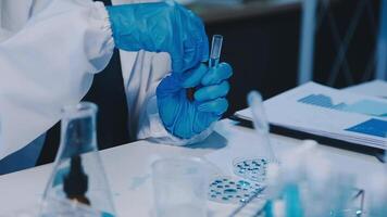 Scientists analyzing coronavirus study data and evaluating microscope. Health care researchers doing some research virus with dropper chemical testing and working in life science laboratory. video