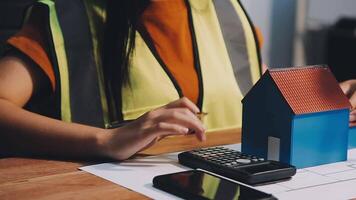 Selective focus, Asian female architect or engineer Currently considering materials for designing modern condominiums. Asian female architect or engineer Sit and analyze, design projects in the office video