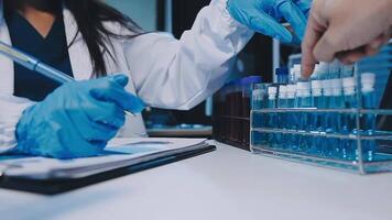 Scientists analyzing coronavirus study data and evaluating microscope. Health care researchers doing some research virus with dropper chemical testing and working in life science laboratory. video