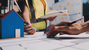 Selective focus, Asian female architect or engineer Currently considering materials for designing modern condominiums. Asian female architect or engineer Sit and analyze, design projects in the office video