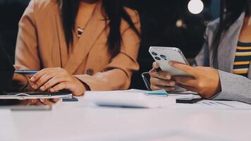 Office colleagues have a casual discussion. During a meeting in a conference room, a group of business teem sit in the conference room new startup project video