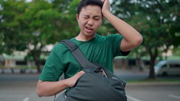 A man with a backpack searched his own bag and realized that he had lost something. video