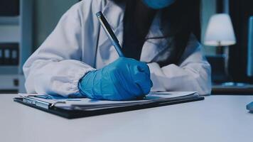Scientists analyzing coronavirus study data and evaluating microscope. Health care researchers doing some research virus with dropper chemical testing and working in life science laboratory. video