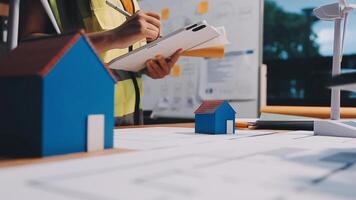 Selective focus, Asian female architect or engineer Currently considering materials for designing modern condominiums. Asian female architect or engineer Sit and analyze, design projects in the office video