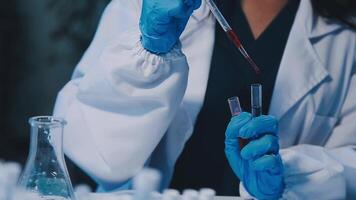 Scientists analyzing coronavirus study data and evaluating microscope. Health care researchers doing some research virus with dropper chemical testing and working in life science laboratory. video