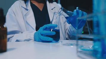 Scientists analyzing coronavirus study data and evaluating microscope. Health care researchers doing some research virus with dropper chemical testing and working in life science laboratory. video