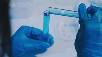 Scientists analyzing coronavirus study data and evaluating microscope. Health care researchers doing some research virus with dropper chemical testing and working in life science laboratory. video