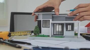 architect man working with laptop and blueprints,engineer inspection in workplace for architectural plan,sketching a construction project ,selective focus,Business concept vintage color video