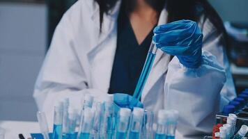 Scientists analyzing coronavirus study data and evaluating microscope. Health care researchers doing some research virus with dropper chemical testing and working in life science laboratory. video