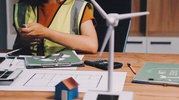 Selective focus, Asian female architect or engineer Currently considering materials for designing modern condominiums. Asian female architect or engineer Sit and analyze, design projects in the office video