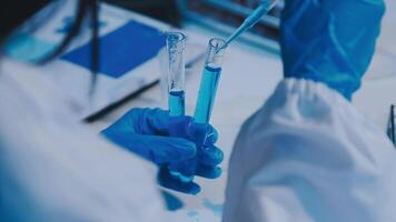 Scientists analyzing coronavirus study data and evaluating microscope. Health care researchers doing some research virus with dropper chemical testing and working in life science laboratory. video