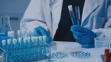 Scientists analyzing coronavirus study data and evaluating microscope. Health care researchers doing some research virus with dropper chemical testing and working in life science laboratory. video