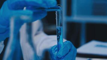 Scientists analyzing coronavirus study data and evaluating microscope. Health care researchers doing some research virus with dropper chemical testing and working in life science laboratory. video