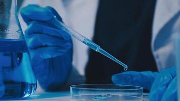 Scientists analyzing coronavirus study data and evaluating microscope. Health care researchers doing some research virus with dropper chemical testing and working in life science laboratory. video