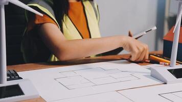 Selective focus, Asian female architect or engineer Currently considering materials for designing modern condominiums. Asian female architect or engineer Sit and analyze, design projects in the office video